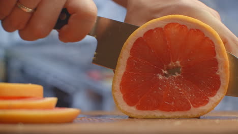 Cut-grapefruit-on-a-wooden-board-closeup.-shred.